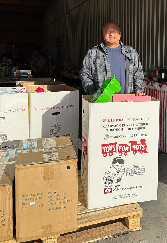 Rico Remigio is shown with boxes of toys at a Toys for Tots collection facility.