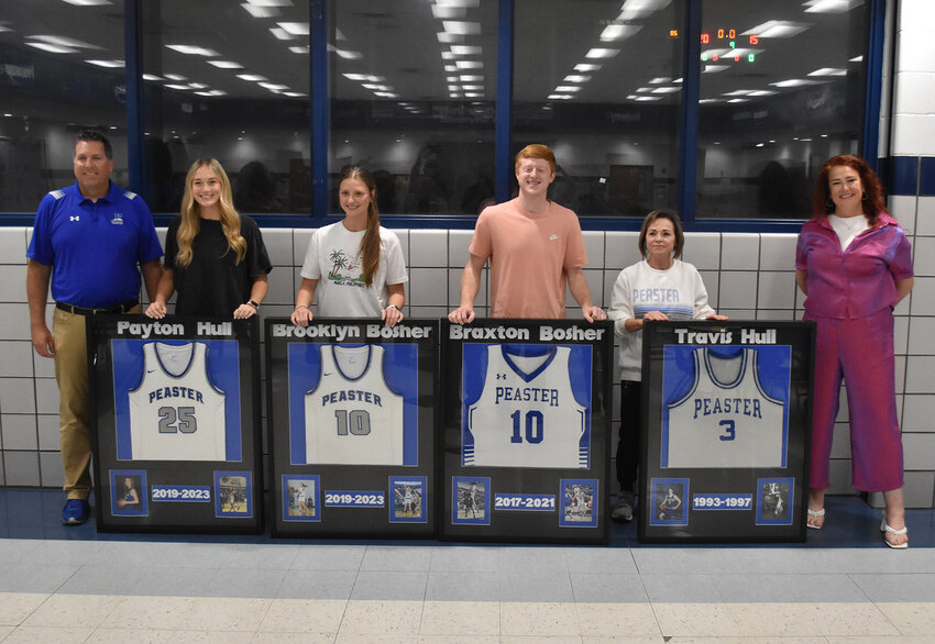 Coach Garrett Hilton, Payton Hull, Brooklyn Bosher, Braxton Bosher, Jo Anne Hull (Payton’s grandmother), and assistant girls coach Kirstin Otel show off the retired jerseys at a May presentation in Peaster High School.