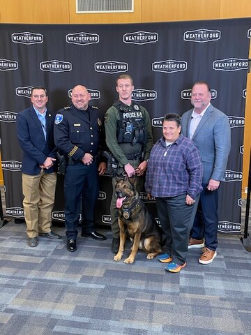 (From left) Weatherford City Council member Zack Smith, Police Chief Lance Arnold, officer Preston Harper K-9 Jack, council member Heidi Wilder, and Mayor Paul Paschall. K-9 Jack received a Purple Heart award for being injured in the line of duty while answering a call with Harper..