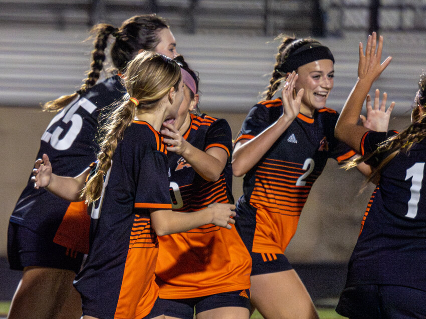 Emery Thompson (2) celebrates with her teammates after scoring in the Ladycats 2-1 loss to Lake Travis in the opening round of the Moritz Kia Tournament on Thursday, Jan. 11.
