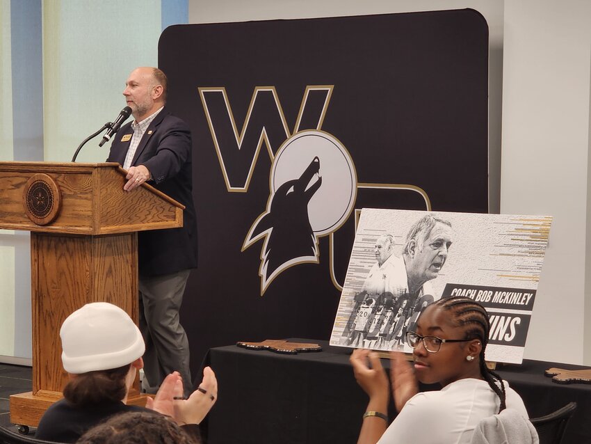 Weatherford College vice president speaks at a reception honoring Lady Coyotes coach Bob McKinley for his 1,000th career victory.
