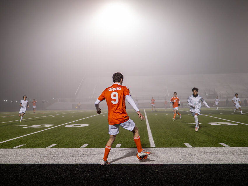 With the fog bearing down, Harrison Hobbs dribbles the ball as a pair of Benbrook defenders close in.