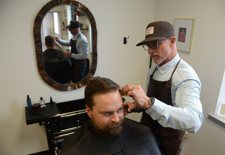 Michael Thompson puts finishing touches on Garrett Pace of Tesajo Properties, Aledo. Bearded Beast is an uber-casual barber shop across from Bryant Grain in Aledo.