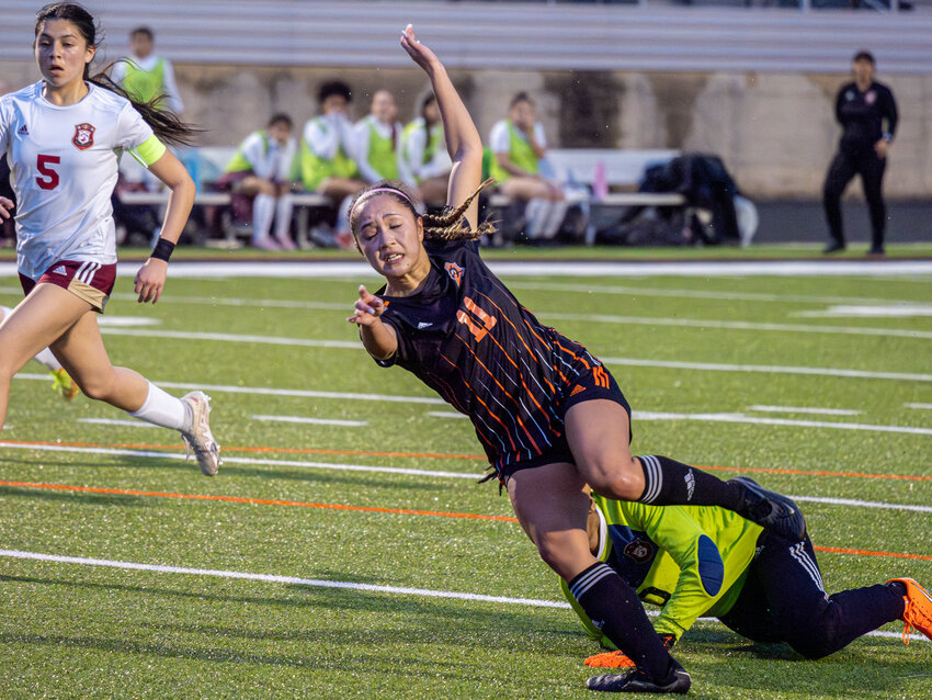 Ladycat midfielder, Hailey Vandiver, is tripped up by the Saginaw keeper as she sprinted for the ball with the goal wide open.