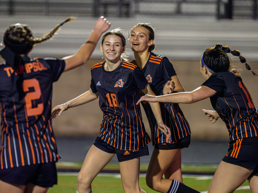 Ladycats swarm teammate Allyson Weimer (18) after she scored a goal. Weimer earned the first hat trick of her varsity career on Friday, Feb. 2, as Aledo defeated Saginaw 3-0.
