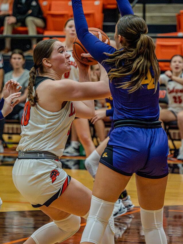 Kinley Elms goes up for a shot with a Sanger defender in her face during a game from December. Elms score 23 points as the Ladycats decimated Wyatt in the bi-district round of the playoffs on Tuesday, Feb. 12.
