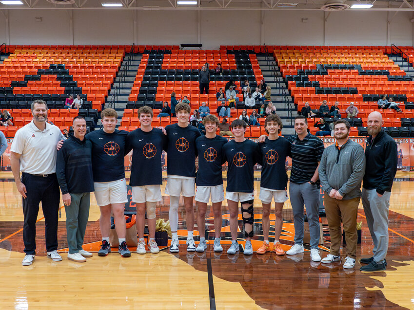 Aledo Bearcat senior basketball players and coaching staff take a photo during the Senior Night ceremony prior to the final home game of the 2023-24 season on Friday, Feb. 9.