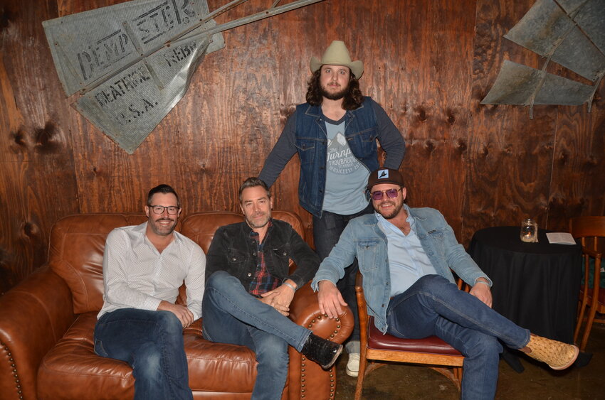 The Josh Weathers band, Blaine Crews, Paul Jenkins, Bubba Bellin and Weathers, relax before their show.