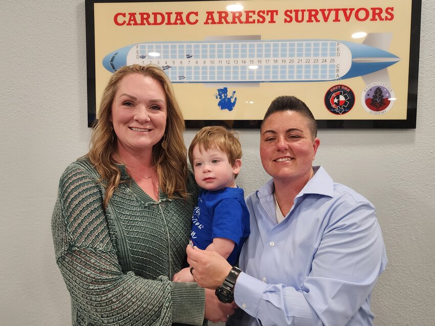 Twenty-month-old Dax Sessom with his parents, Dani (left) and Juleah. Dax was rescued by Parker County EMS team members in late January after having a cardiac arrest.