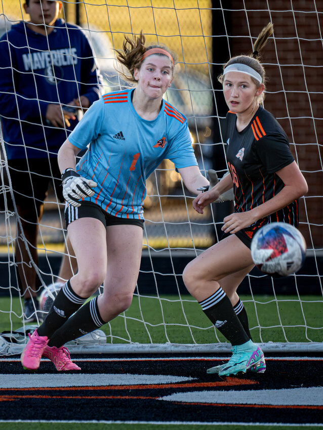 Ladycat goalkeeper, Ava Fennell maneuvers around teammate Baylee Velarde to defend the net during a Midlothian corner kick in the Area Playoff match on Thursday, March 28. Midlothian took 21 shots on goal during the match with Fennell collecting 15 saves.