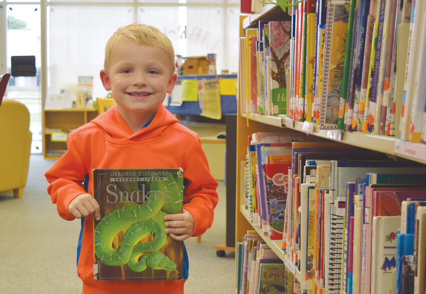 Travis Coleman, age 4, was delighted to find a book about snakes at the East Parker County Library. in 2016.
