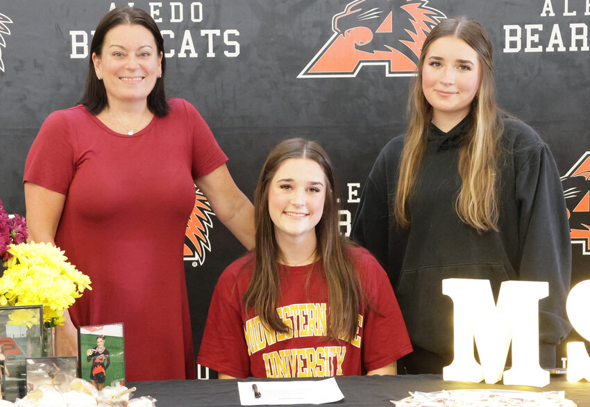 Ellis Johnson signed to join the cheerleading squad at Midwestern State University. She is shown with Courtney and Claudia Johnson.