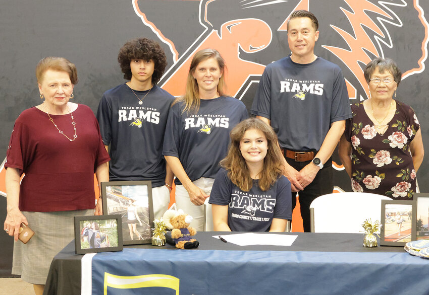 Rags Walker will pole vault at Texas Wesleyan University. She is shown with Ethan, Bill, Cheri, and Noi Walker and Jerrie Goforth.