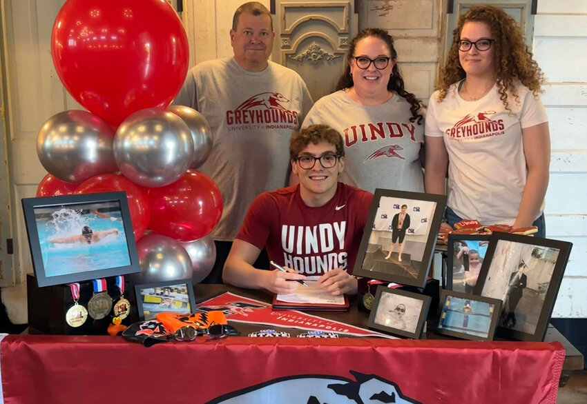 Porter Lane will swim at the  University of Indianapolis. He is shown with Todd Lane, Jennifer Lane, and Charlotte Lane.