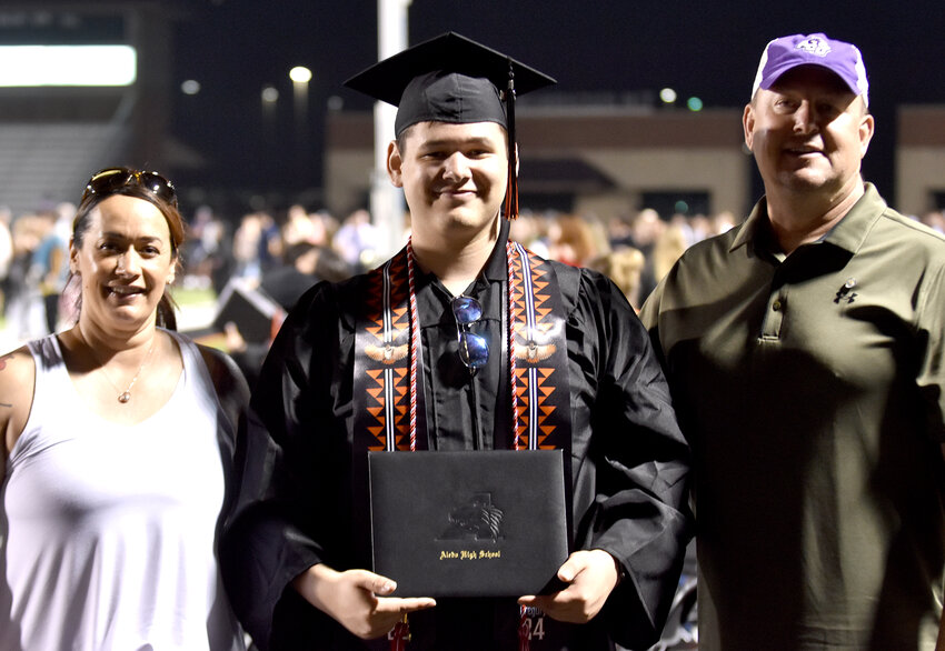 Hunter Gregory is shown with his parents, ????????? and Derek, after the May 24 graduation.