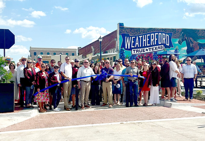 Weatherford Mayor Paul Paschall and city officials and residents joined for a ribbon cutting for the new improvements to the northwest quadrant of the square on June 27.