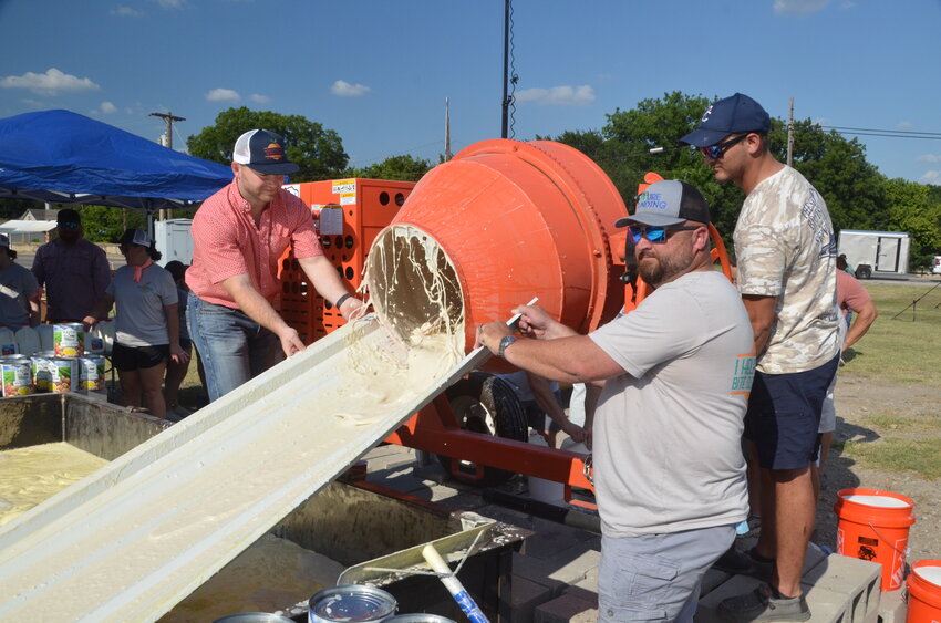 Matt Clark, Mark lusk and Jake Gustainis helped pour hundreds of cement mixers full of cobbler batter for the world record peach cobbler. The enormous treat contained 1,400 canned peaches and 300 gallons of milk, which was baked and served at Parker County Peach Fest 2024.