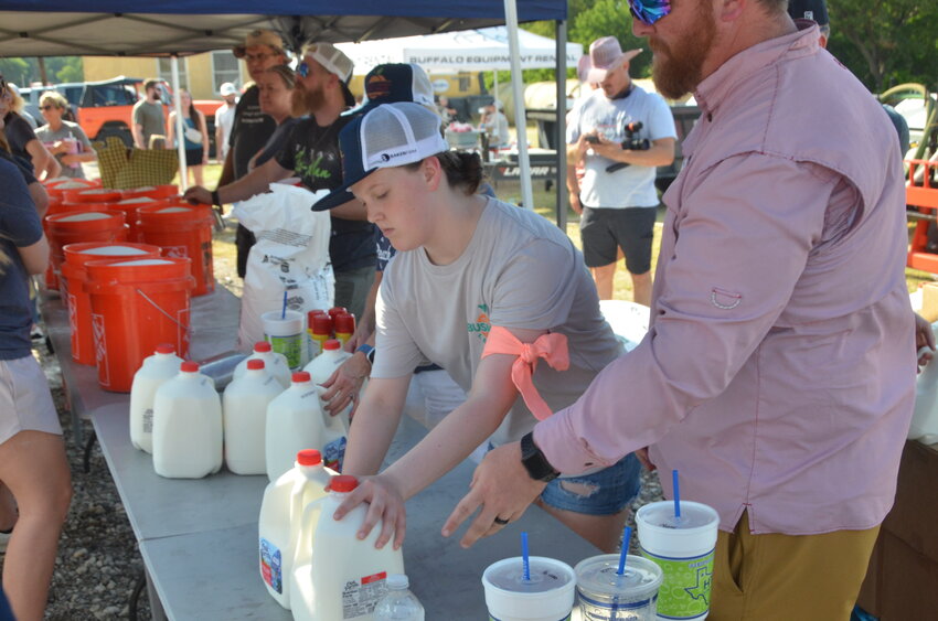 Event watchers were encouraged to help on the assembly line, keeping five gallon buckets of batter and 300 gallons of milk moving to the mixer.
