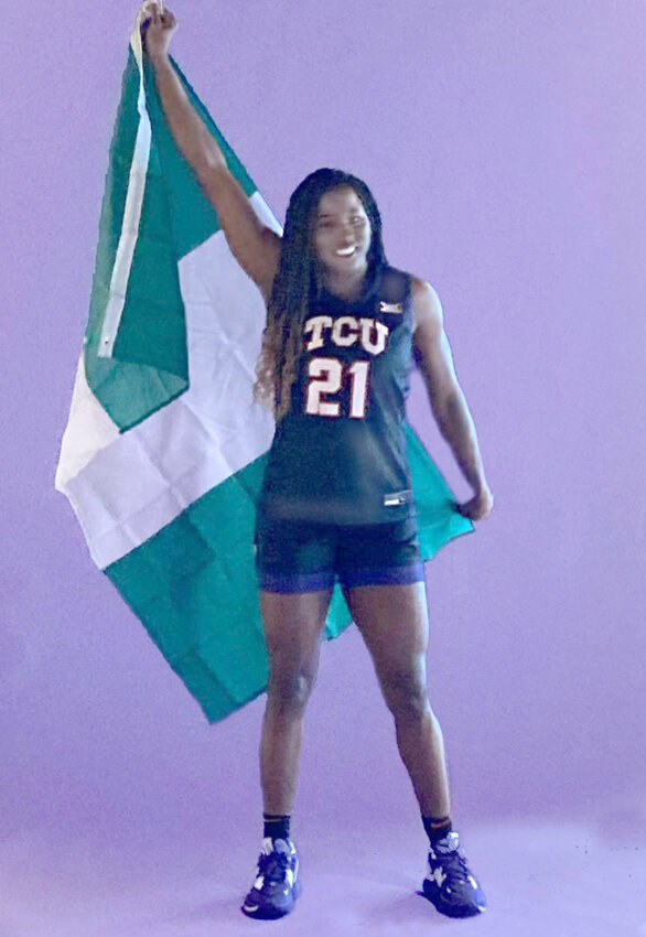 Lucy Ibeh drapes herself in the Nigerian flag while posing in her TCU.uniform. Ibeh earned a master's degree from TCU.