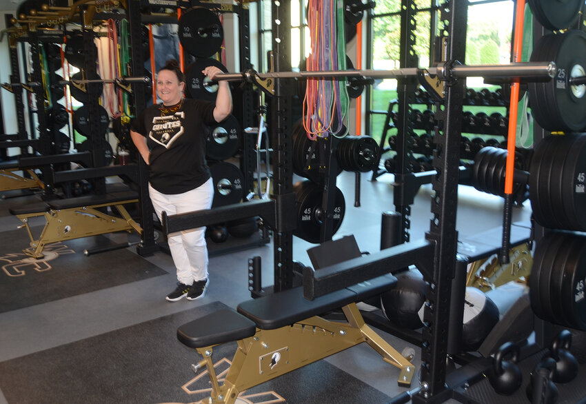 Keynote speaker and head softball coach Kaylee Williams shows visitors the weight lifting room on the first floor of Durant Hall.