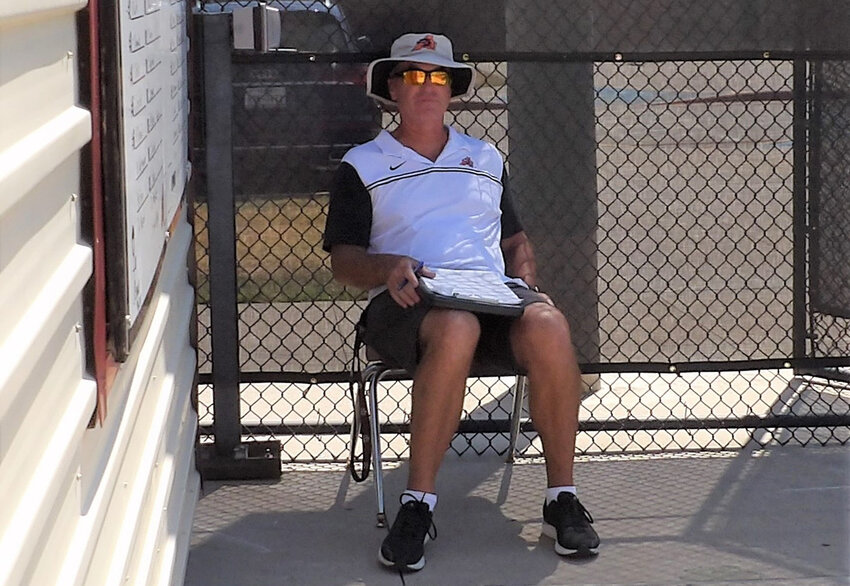 Aledo tennis coach Joe McCoy escapes the heat during a recent match.