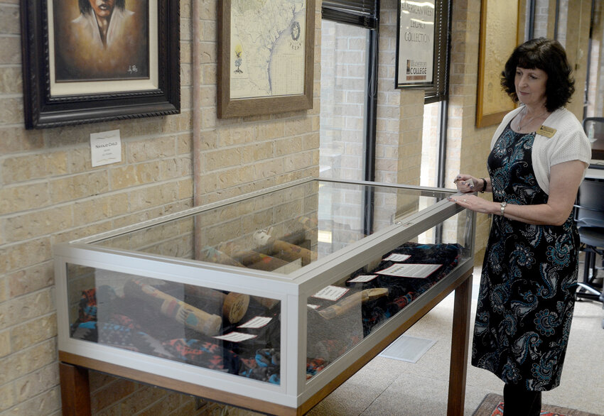 Library Director Valorie Starr shows a case of Hopi Kachina Dolls in the Murphey Western Institute collection.