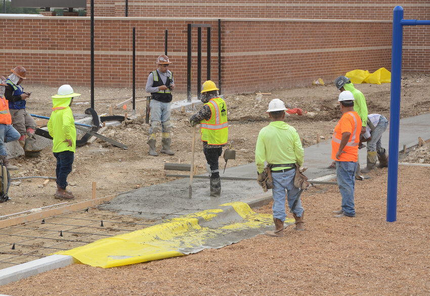 Sidewalks are poured past one of McKinney Elementary School's two playgrounds.