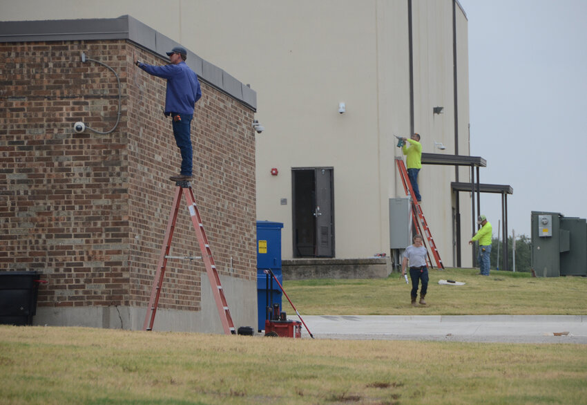 Williams Electric Co. crews install enhanced security on the west side of Aledo Middle School.