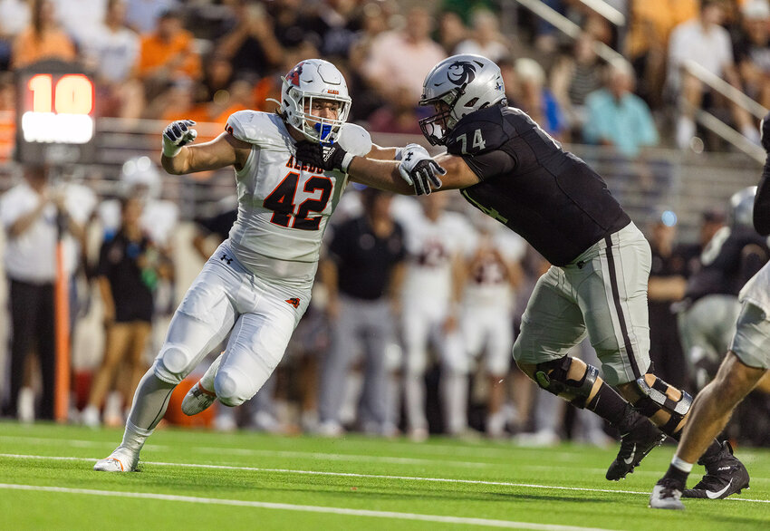 Defensive end Cooper Cyphers (42) applies pressure during the Guyer game.