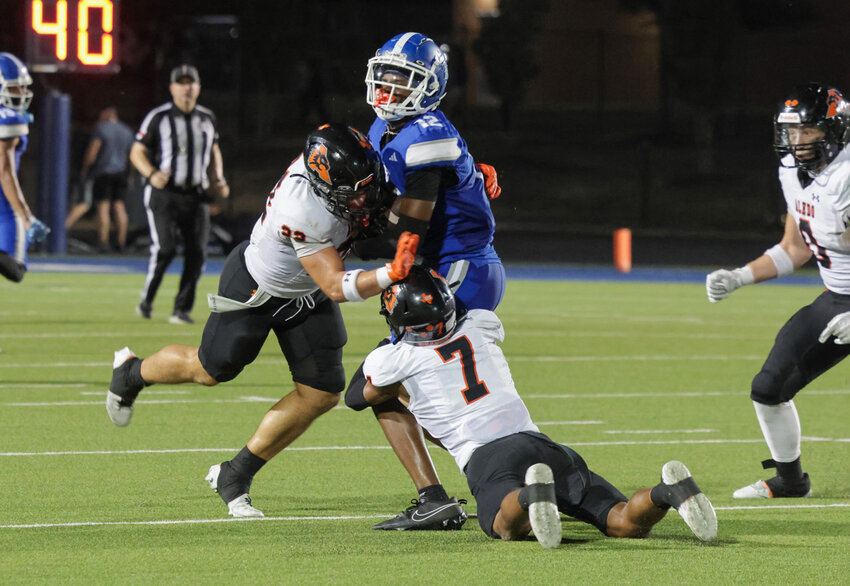 Cornerback Adrian Fuller (7) and safety Ben McElree (22) pull down a Brewer runner.