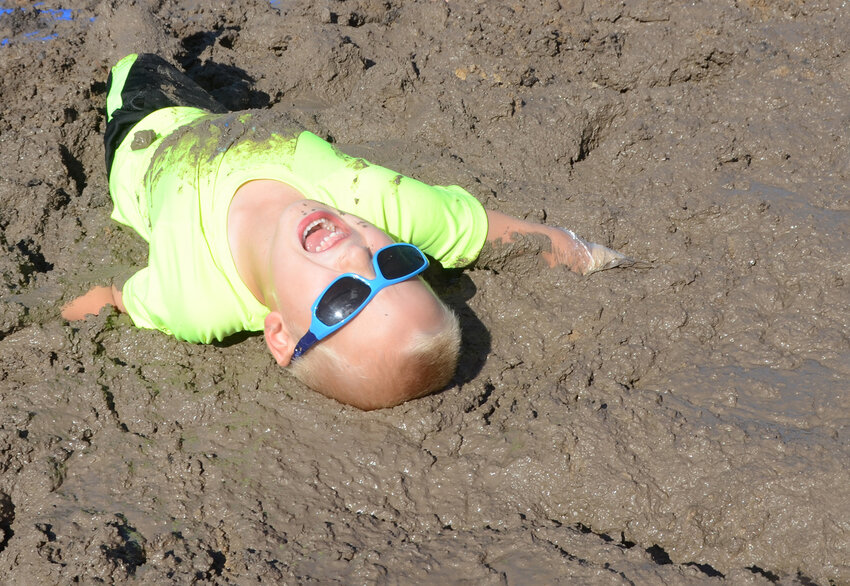 Jonah Blassingame fully emerges himself in the joy of getting muddy.