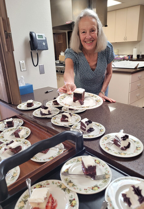 Nancy Deison serves coffee and cake after a service.