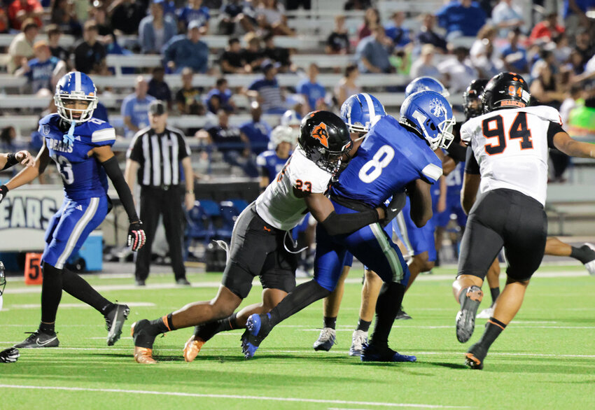 Safety Kamron Hall (23) and defensive end Samuel Pimental (94) overwhelm the Brewer backfield.