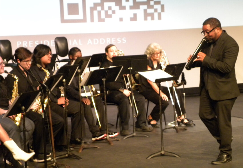 Director Fredrick Sanders plays the melodica with the Coyote Jazz Band as the group performs at the Presidential Luncheon in the Marjorie Alkek Fine Arts Center.