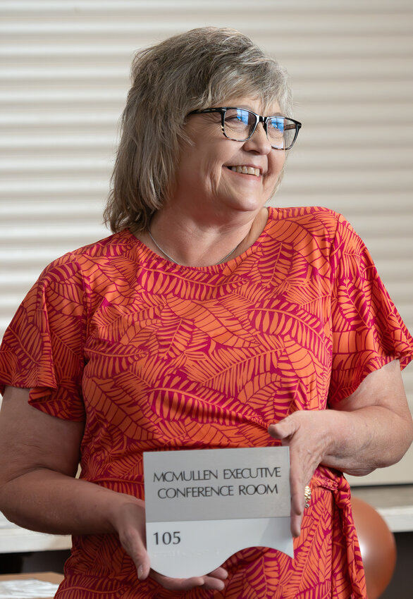 Deana McMullen proudly displays the placard bearing her name that will hang in the new Aledo City Hall upon completion.