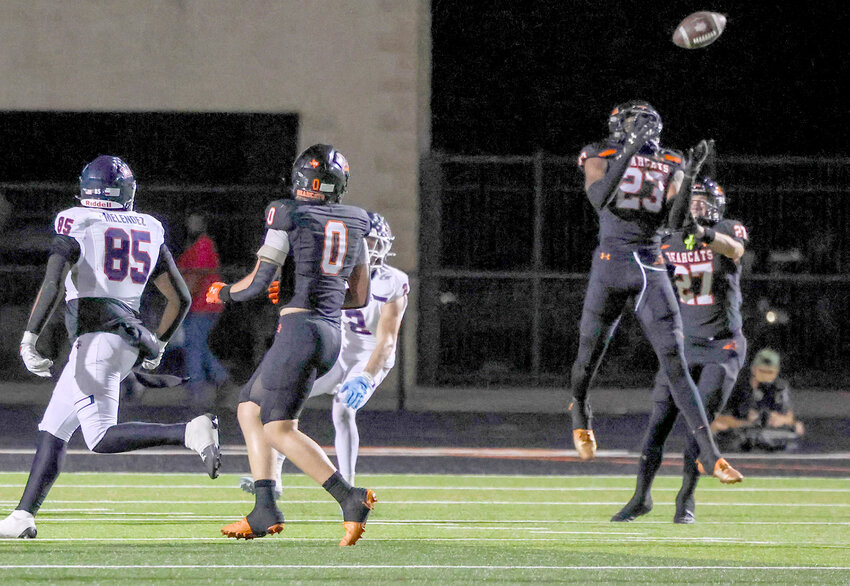 Kamron Hall (23) leaps for an interception.