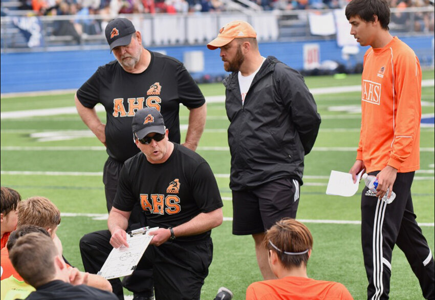 Derek Vierling coaches his soccer players. Also shown are coaches Billy Warren and Bryan Johnson.