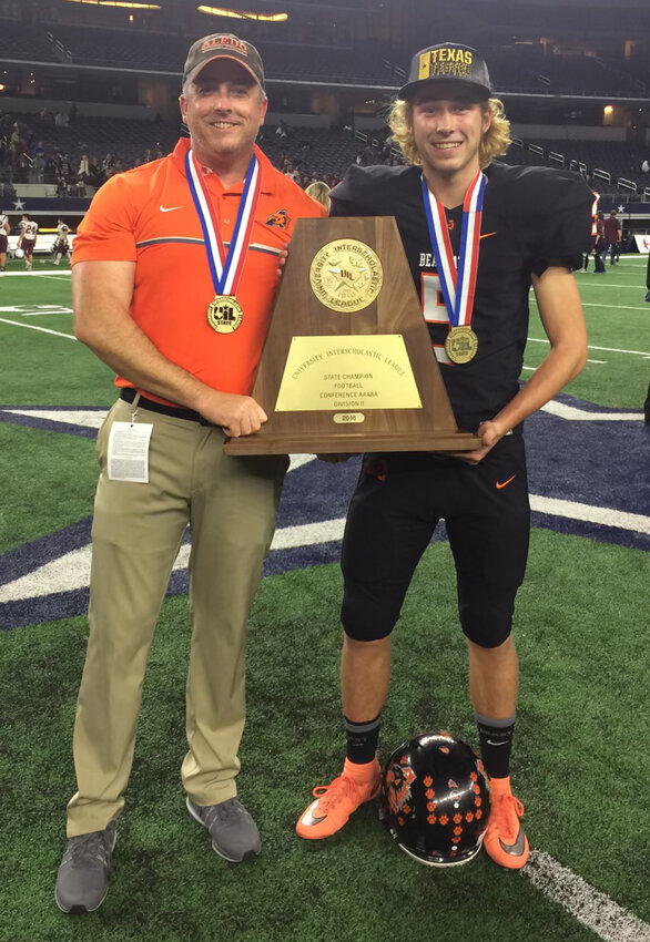 Derek celebrates with son Reid following the 2016 Aledo football state championship.