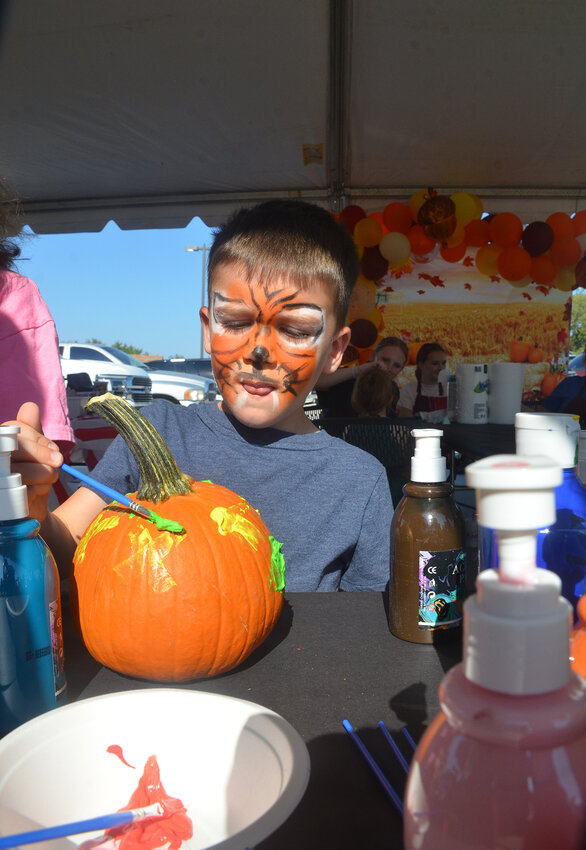 Rowan Lapenna paints his self portrait on a pumpkin, one of the many activities at Aledo Methodist Church's Lord's Acre Saturday, Oct.12.