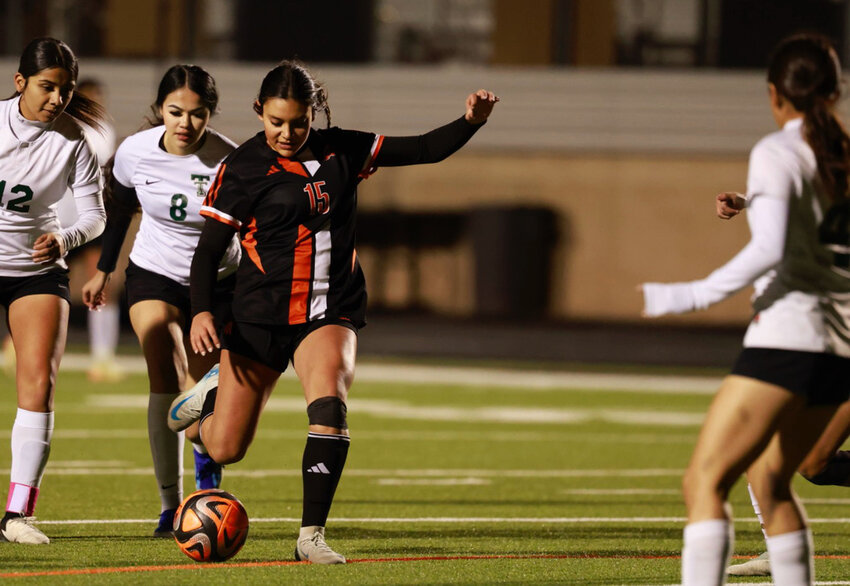 Avery Sands moves the ball past Trimble Tech defenders.