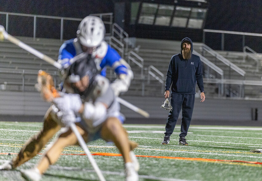 Aledo lacrosse coach Athan Iannucci looks on as two athletes compete in a rodeo drill during practice on Thursday, Jan. 30.