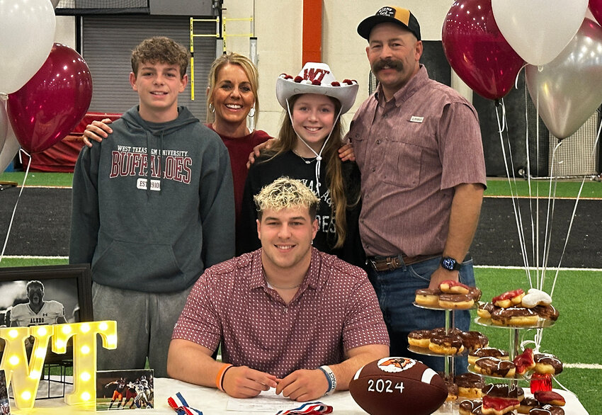 Cody Cartwright will play football at West Texas A&M University. He is shown with Royce, Jill, Catie, and Cason.