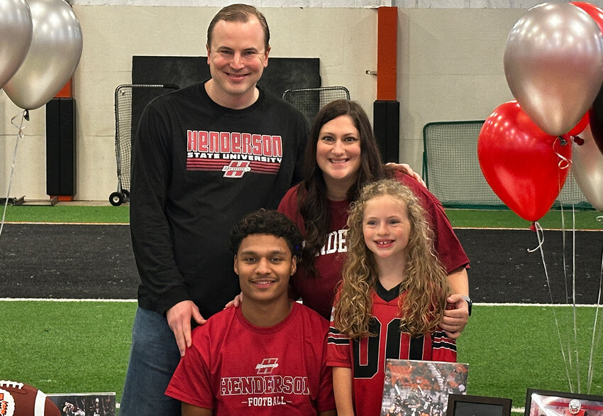 Adrian Fuller will play football at Henderson State University. He is shown with Martin, Allison, and Aspen.