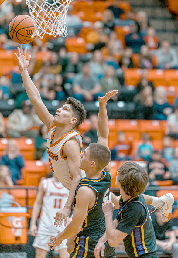 Senior guard Joaquin Pacheco gets by a pair of Granbury players to put up a shot during the Bearcats' 60-47 victory to stay atop the District 5-5A standings.
