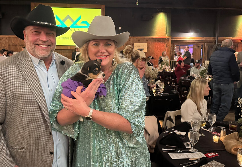 Jeff and Donya Benson display a Corgi that was to be auctioned later in the event.