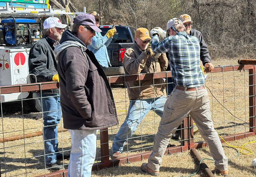 Jimmy Britton drills, while supervised by (from left) Darren Dietrich, Scott Sadler, David Sides, Geoff Mantooth, and Larry Chapman.
