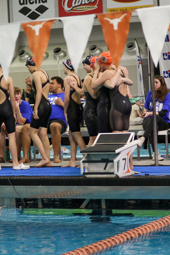 Seniors Haley Roberson and Victoria Crews share a hug after competing for the final time together as members of the Aledo High School swim team. Each advanced to state all four years in the program.