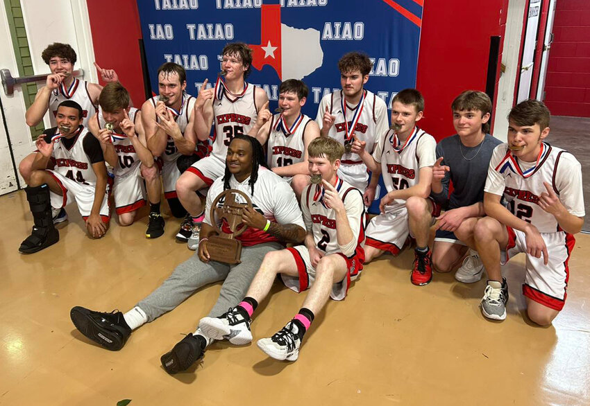 Members of the Weatherford Express homeschool basketball celebrate after winning the Texas Association of Independent Athletic Organizations Division II championship.