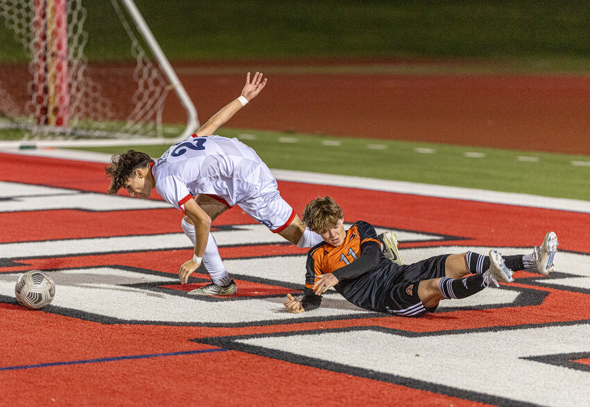 Brody Gill is tripped up and loses possession of the ball near the Richland goal during the first half of the Bearcats' bi-district matchup at Farrington Field on Thursday, March 20.