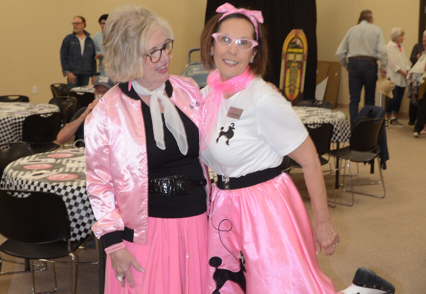Jo Warren of Grace House Ministries and Sanctified Hope founder Janet Duvall show off their 50s-style poodle skirts before the banquet.